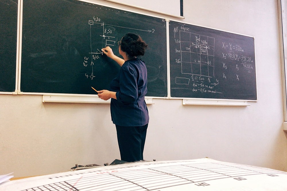 A teacher at the chalkboard
