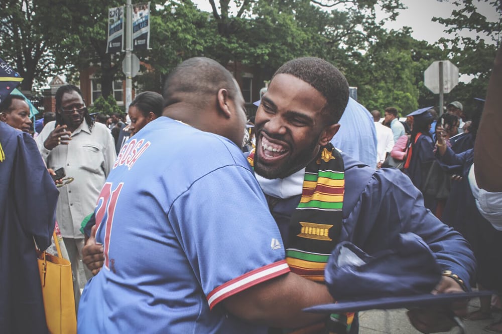 a happy graduate hugs a family member